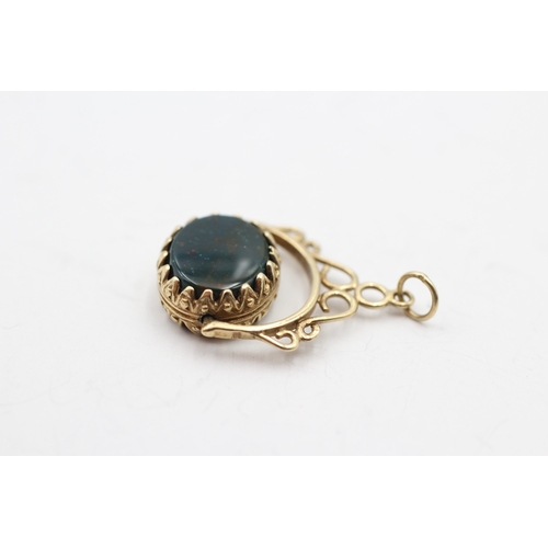 146 - 9ct gold onyx and bloodstone spinner fob (3.2g)