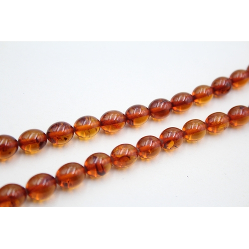 147 - 9ct gold clasped amber bead necklace (19.3g)