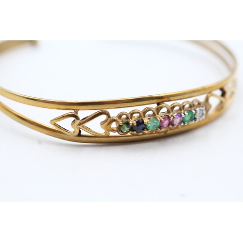 15 - 9ct gold diamond, emerald, amethyst, ruby, sapphire and tourmaline 'dearest' bangle (5.1g)