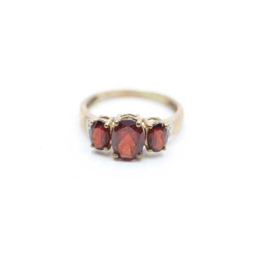 212 - 9ct gold garnet and diamond set dress ring (2.5g) Size P