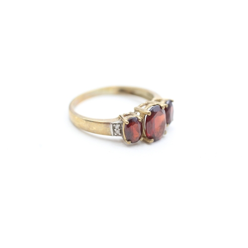 212 - 9ct gold garnet and diamond set dress ring (2.5g) Size P