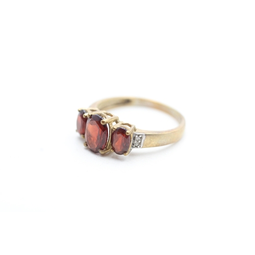 212 - 9ct gold garnet and diamond set dress ring (2.5g) Size P