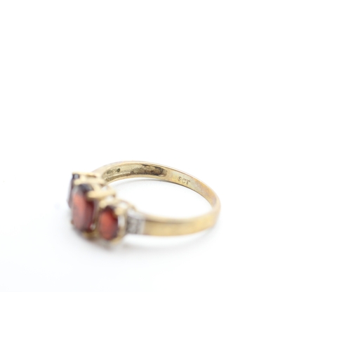 212 - 9ct gold garnet and diamond set dress ring (2.5g) Size P