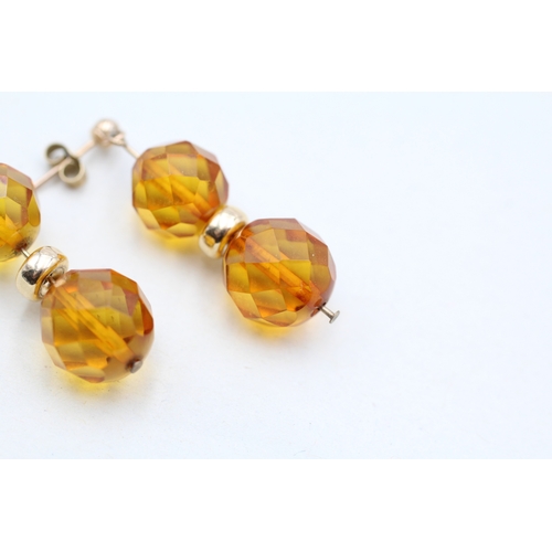 216 - 9ct gold faceted amber bead drop earrings (2.7g)