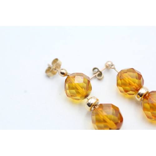 216 - 9ct gold faceted amber bead drop earrings (2.7g)