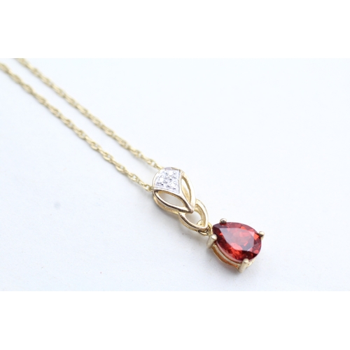 221 - 9ct gold diamond accented garnet set pendant necklace (1.9g)