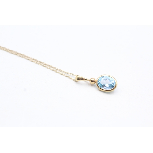 237 - 9ct gold blue topaz pendant on chain (0.9g)