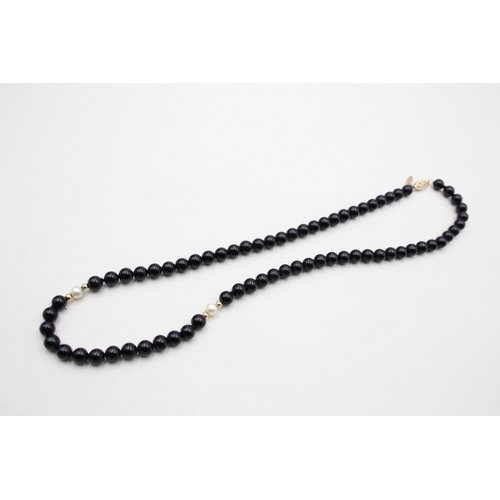 43 - 14ct gold onyx and pearl necklace (22.5g)