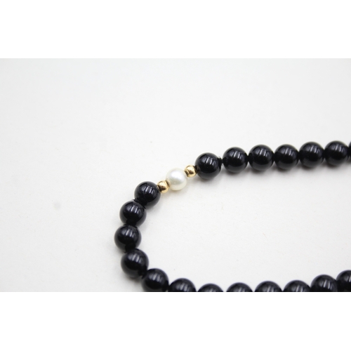 43 - 14ct gold onyx and pearl necklace (22.5g)