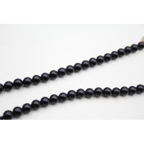 43 - 14ct gold onyx and pearl necklace (22.5g)