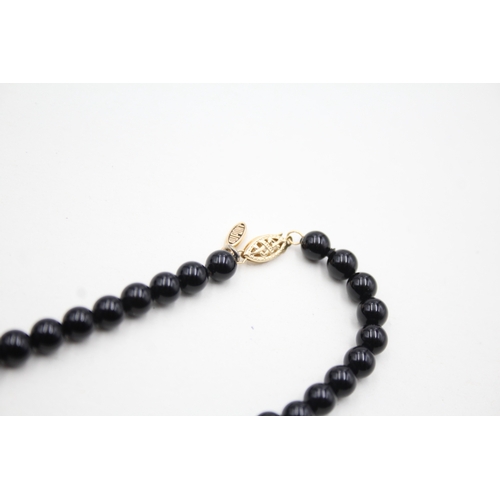 43 - 14ct gold onyx and pearl necklace (22.5g)