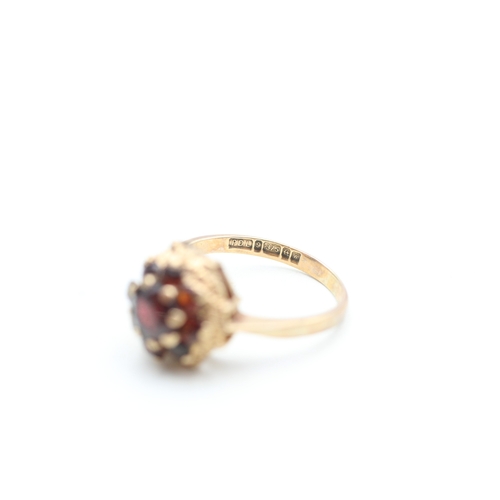 139 - 9ct gold garnet set floral cluster ring (2.7g) Size K