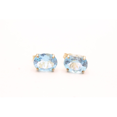 143 - 9ct gold oval cut blue gemstone stud earrings (2.3g)