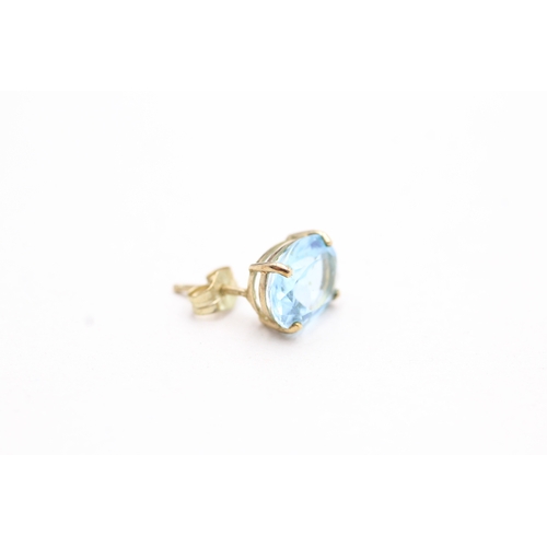 143 - 9ct gold oval cut blue gemstone stud earrings (2.3g)