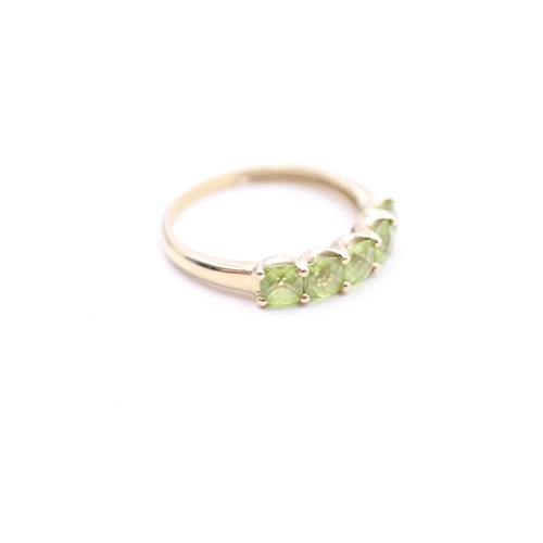 187 - 9ct gold peridot row ring (2.2g) Size Q