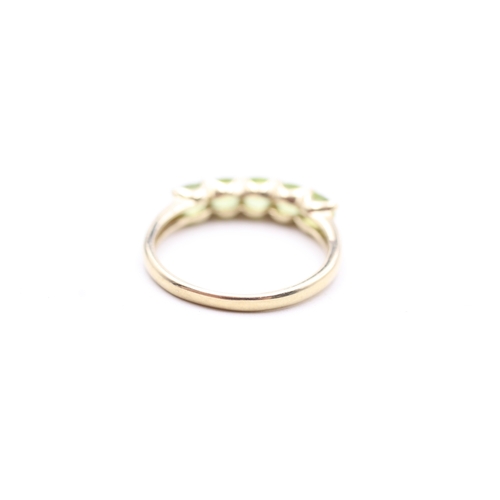 187 - 9ct gold peridot row ring (2.2g) Size Q