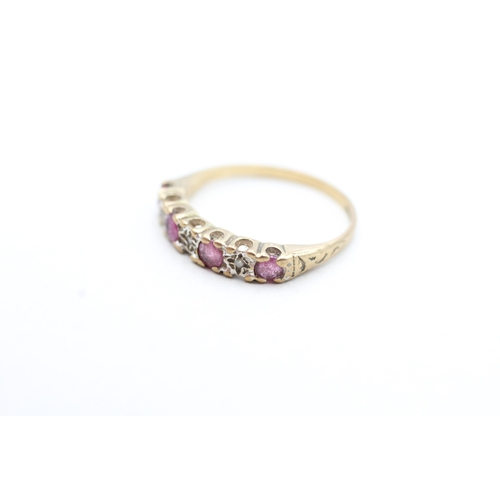 229 - 9ct gold ruby and diamond set seven stone eternity ring (1.5g) Size K