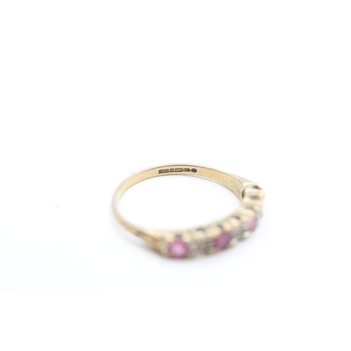 229 - 9ct gold ruby and diamond set seven stone eternity ring (1.5g) Size K