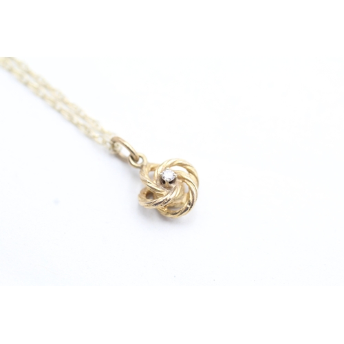 239 - 9ct gold diamond knot pendant on chain (1.7g)