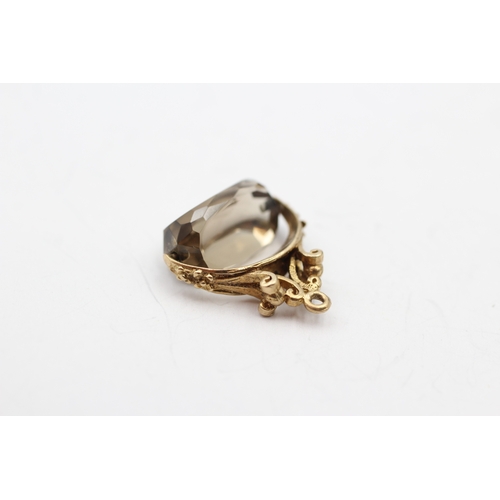 56 - 9ct gold smokey quartz spinner fob (2.7g)