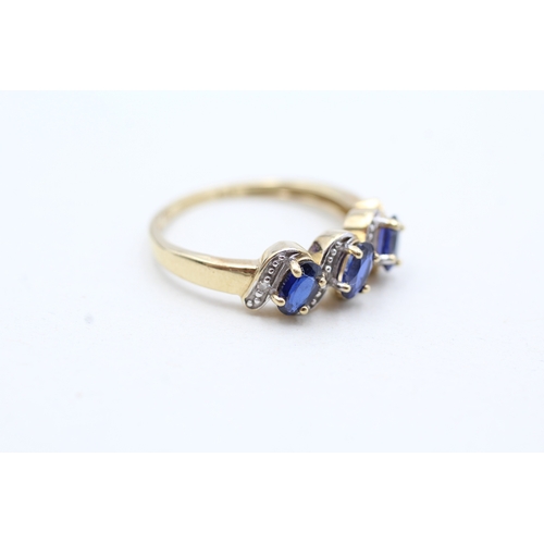 94 - 9ct gold diamond and blue gemstone twist row ring (2.1g) Size N