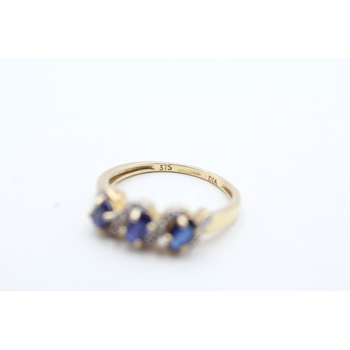 94 - 9ct gold diamond and blue gemstone twist row ring (2.1g) Size N