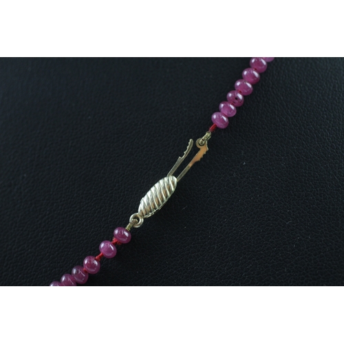 109 - 9ct gold clasped ruby bead necklace (10.4g)