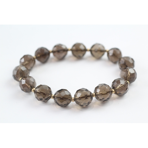 13 - Smoky quartz bead bracelet with 9ct gold spacer beads (23.3g)