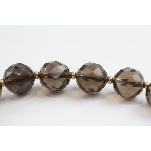 13 - Smoky quartz bead bracelet with 9ct gold spacer beads (23.3g)