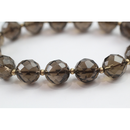 13 - Smoky quartz bead bracelet with 9ct gold spacer beads (23.3g)