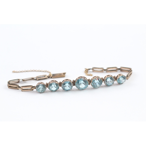 146 - 9ct gold blue zircon bracelet (7g)