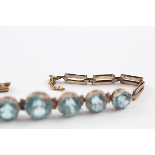 146 - 9ct gold blue zircon bracelet (7g)