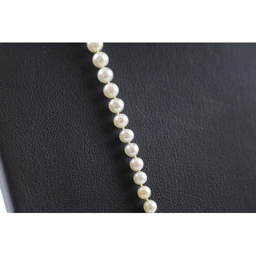 150 - 9ct gold and silver diamond set clasp graduated pearl necklace (8.6g)