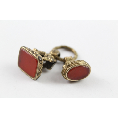 193 - Two gold plated carnelian seal fobs and split ring (16g)