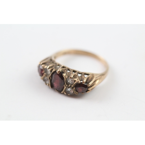 215 - 9ct gold garnet and white gemstone gypsy set ring (3.8g) Size O 1/2