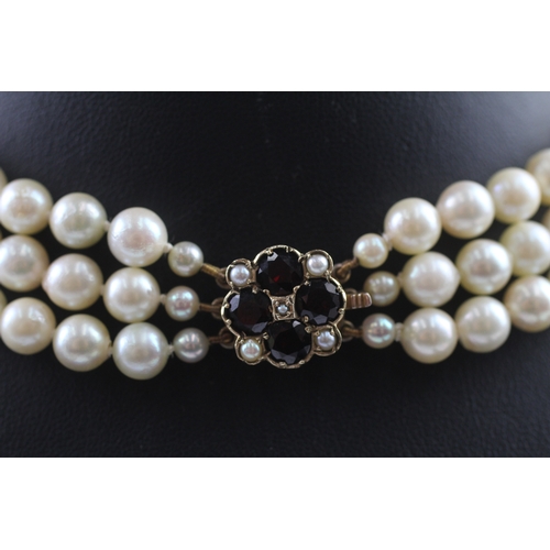 235 - 9ct gold and garnet clasped pearl necklace (67.6g)