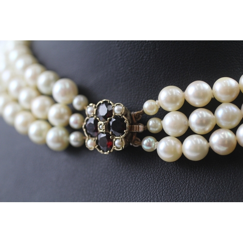 235 - 9ct gold and garnet clasped pearl necklace (67.6g)