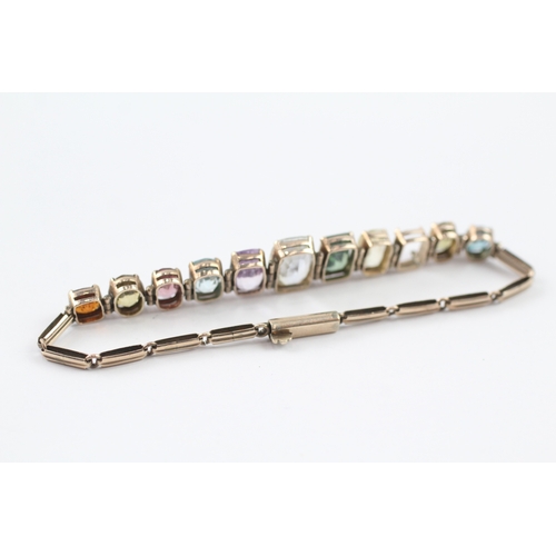 274 - 9ct gold multi stone panel bracelet with garnet, zircon, purple and yellow sapphire (10g)