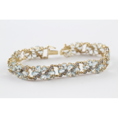 288 - 9ct gold diamond and topaz floral bracelet (18.2g)