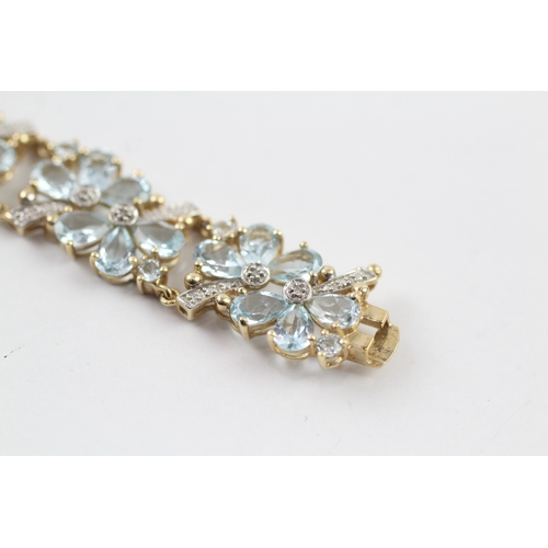 288 - 9ct gold diamond and topaz floral bracelet (18.2g)