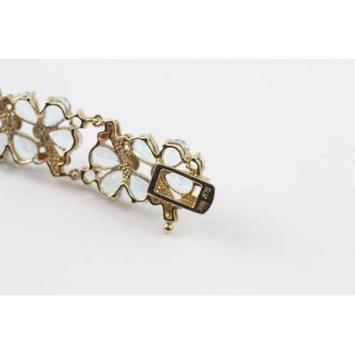 288 - 9ct gold diamond and topaz floral bracelet (18.2g)