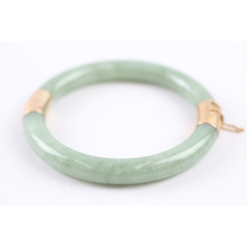 301 - 14ct gold jade bangle (36.4g)