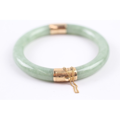 301 - 14ct gold jade bangle (36.4g)