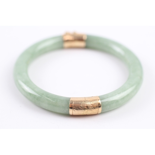 301 - 14ct gold jade bangle (36.4g)