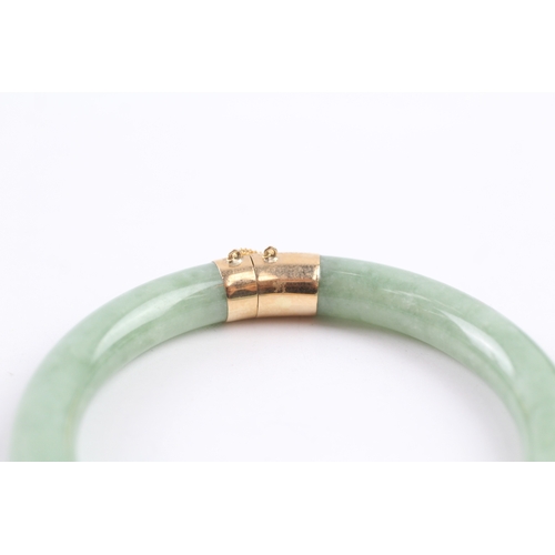 301 - 14ct gold jade bangle (36.4g)