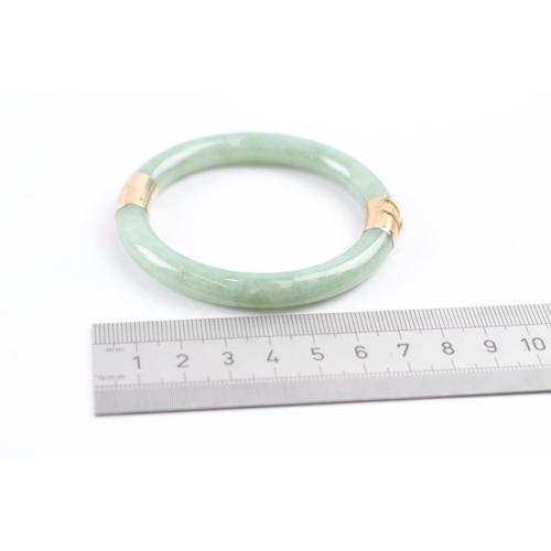 301 - 14ct gold jade bangle (36.4g)