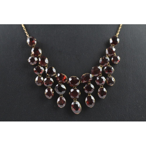 302 - 9ct gold garnet fringe necklace (15.8g)