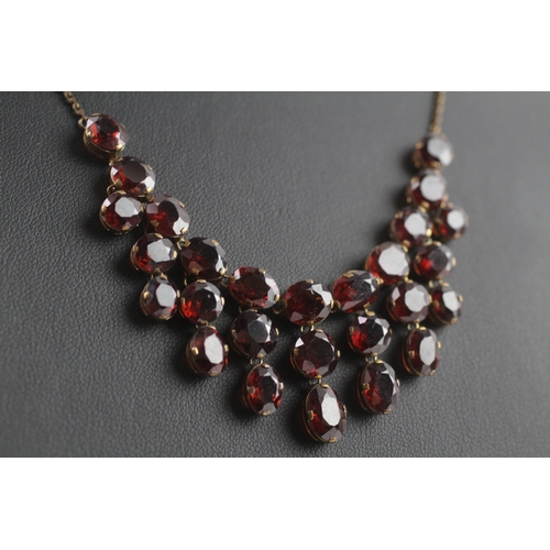 302 - 9ct gold garnet fringe necklace (15.8g)