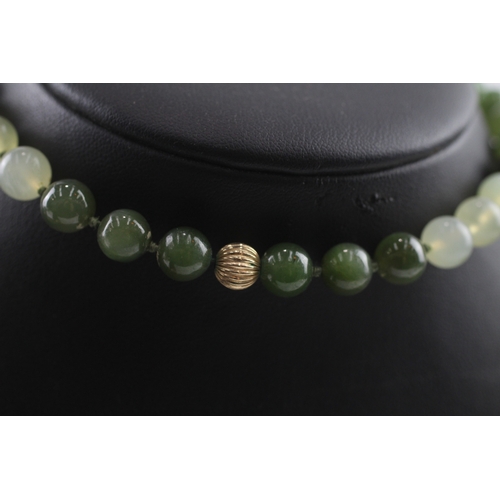 319 - 9ct gold clasped nephrite and carved bowenite necklace (71g) Size P 1/2