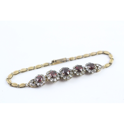 323 - 6ct gold vintage garnet and white sapphire graduated halo bracelet (10.5g)